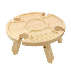 a small wooden table with four compartments on it's legs and one section missing the lid