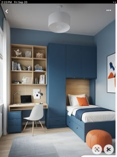 a bedroom with blue walls and furniture in the corner, including a bed that has an orange pillow on top of it