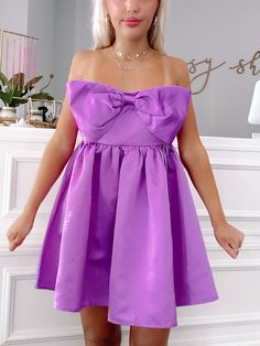 Meet the Regal Ribbon Bow Dress from Sassy Shortcake! This vibrant purple dress features a charming bow and a flattering strapless design. The elegant, soft satin fabric and smocked back provide both comfort and style. Perfect for any special occasion, this dress will make you stand out in a crowd. fit: stretchy fit, runs a bit big (model wearing a size small) content: 100% polyester care: hand wash cold Satin Purple Dress, Sassy Shortcake, Patriotic Dresses, Purple Bow, Purple Bows, Bow Dress, Vibrant Purple, Ribbon Bow, Satin Dress