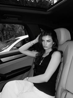 a woman sitting in the back seat of a car