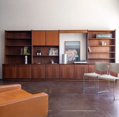 a living room filled with furniture and bookshelves