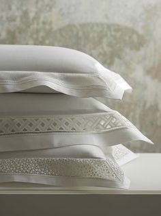 three white pillows stacked on top of each other