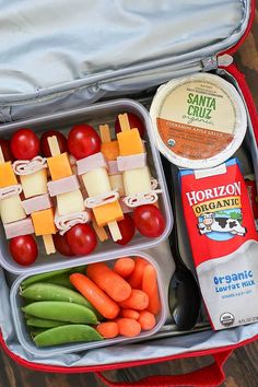 an open lunch box filled with fruit and veggies