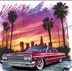 an old red car parked in front of palm trees and the sun setting behind it