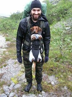 a man with a dog in his back pack