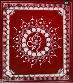 a red and white bandanna with an intricate design in the center, on top of a