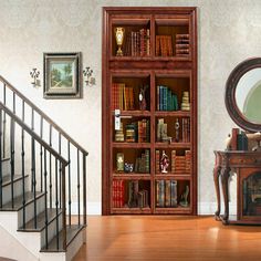 a bookcase with many books in it next to a mirror