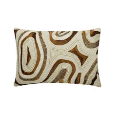 a brown and white pillow with swirls on the front, sitting on a white background