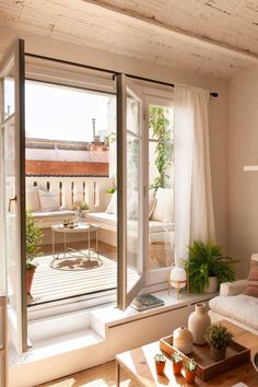 a living room filled with furniture and lots of windows