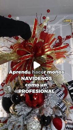 a christmas tree decorated with red, white and gold ornaments is shown in this video