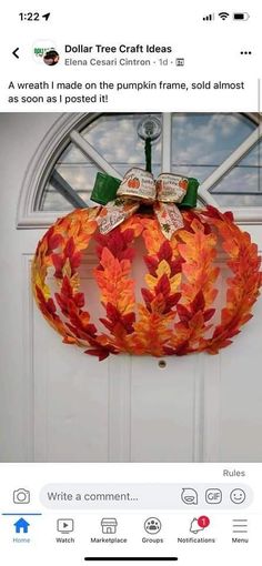 a paper pumpkin hanging on the front door