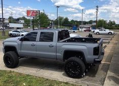 a silver truck parked in a parking lot