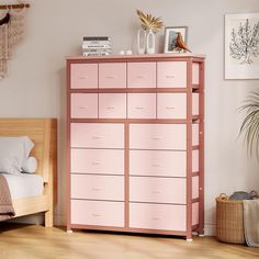 a pink dresser with drawers in a bedroom