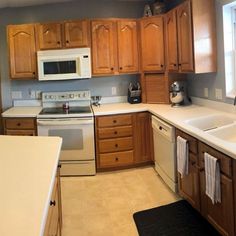 a kitchen with wooden cabinets and white appliances