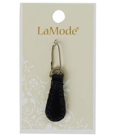 a pair of black leather mitts hanging from a hook on a white and gold card