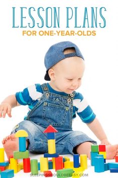 a baby sitting on the floor playing with blocks and building toys for one year olds