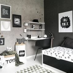 a bedroom with black and white decor on the walls