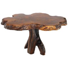 a wooden table that has been carved into the shape of a tree trunk and is sitting on