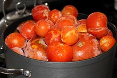 a pot filled with lots of tomatoes on top of a stove