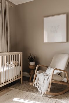 a baby's room with a rocking chair, crib and pictures on the wall