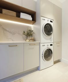 a washer and dryer in a white laundry room