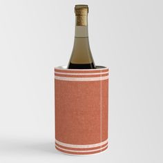 a bottle of wine in a red and white striped canister with a cork top