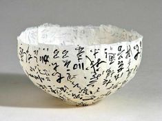 a white bowl with black writing on it