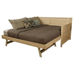 a bed that has pillows on it and is made out of wood with no headboard