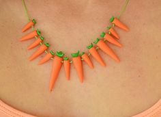 "This food inspired carrot necklace is bound to bring a smile to your vegan friend. The bright orange and green necklace makes unique Christmas present.  🥕 Handmade necklace  🥕 Polymer clay  🥕 Biggest carrot - 45 mm (2\") This polymer clay necklace has been designed and made by myself. Every piece is individually handmade, which makes each one similar, but unique. If you like them, but you wish to have them in different color, size or shape, don't hesitate to write me about your desires. Welcome to my shop, where you can find a gift for you, for a friend or for your loved ones. My creations are entirely handmade from polymer clay and resin. Jewelry, women's earrings, sculptures, women's bracelets, necklaces for women and accessories. I've been working with polymer clay for 15 years and Carrot Necklace, Orange Polymer Clay, Orange Carrots, Polymer Clay Food, Food Necklace, Necklace Polymer Clay, Food Inspired, Vegan Jewelry, Necklace Orange