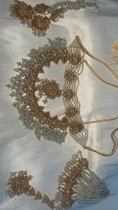 several different types of necklaces on a white cloth