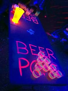 a neon beer pong sign is lit up at night