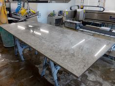 an industrial kitchen with stainless steel appliances and marble counter tops in the process area,