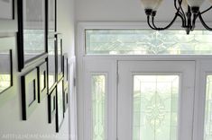 a white door with two glass panels and a chandelier