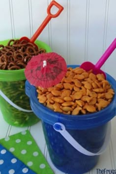 two buckets filled with cereal and an umbrella