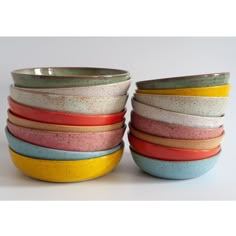 a stack of colorful bowls sitting on top of each other