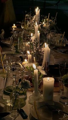 the table is set with candles and dishes