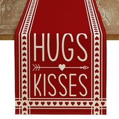 a red and white sign that says hugs kisses