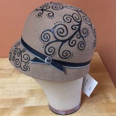 Nwt- Unique Structured Cloche Hat. Handmade In Chicago. Light Brown 100% Light Wool. Hand-Painted With Black Swirl Design With Zipper And Button Detail. Size Small: 21 5/8” Circumference (Hand Measured By Me And May Have Slight Variation If Measured By Someone Else). One Chicago, Unique Hats, Hat Handmade, Cloche Hat, Swirl Design, Button Detail, Black And Tan, Hat Fashion, Light Brown