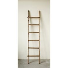 an old wooden ladder leaning against a wall