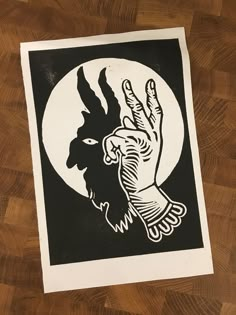 a black and white drawing of a hand holding the moon