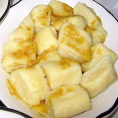 a white plate topped with sliced bananas on top of a table