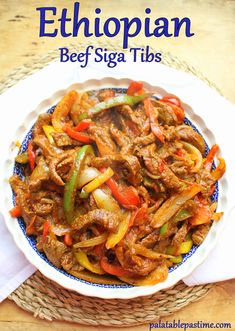 a bowl filled with beef and peppers on top of a table