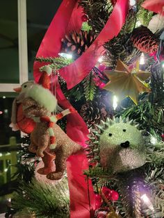 a christmas tree with ornaments and lights in the shape of teddy bears on it's sides