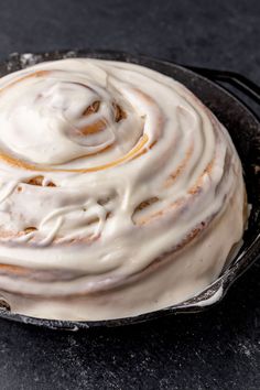 a close up of a cake in a pan with icing on the top and bottom