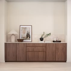 a wooden cabinet with two vases on top of it and a painting hanging above