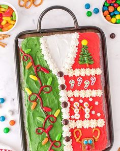 a cake decorated with the flag of italy on top of a baking sheet surrounded by candies and pretzels