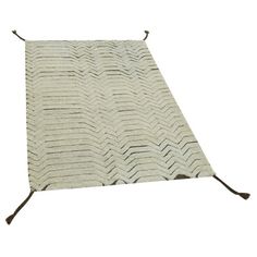 a white rug with brown handles on it and a black handle hanging from the side