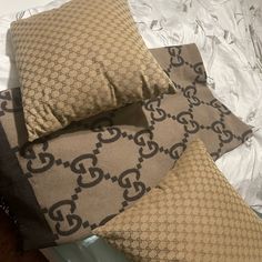 two pillows on top of a bed next to each other