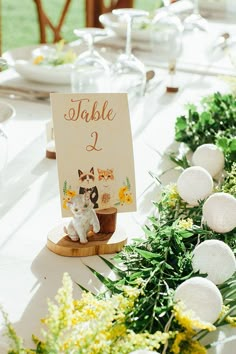 a table set up with place cards and flowers