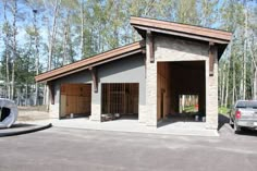 a car is parked in front of a building with two garages on each side